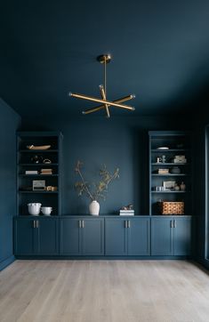 a living room with blue walls and wooden floors is featured in the article house & development