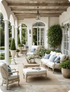 an outdoor living room with couches and tables