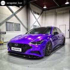 a purple car is parked in a garage