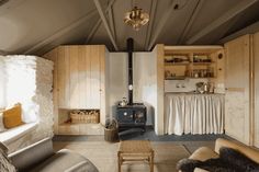 a living room filled with furniture and a wood stove