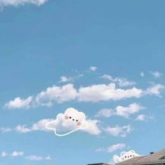 a cloud shaped like a bear floating in the sky with two smaller clouds behind it