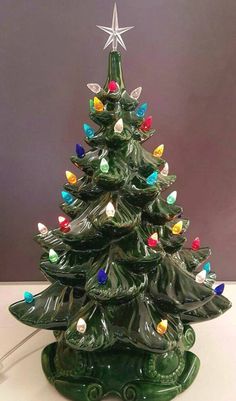 a ceramic christmas tree with lights on it