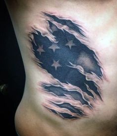 the back of a woman's stomach with an american flag tattoo design on it