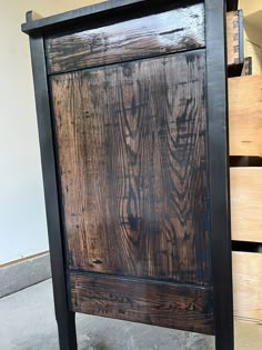 an old wooden bed frame sitting on the floor