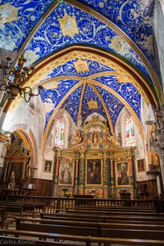 the interior of an old church with blue and gold paint