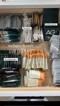 an organized drawer with many different items labeled in english and chinese on the bottom shelf