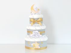 a three tiered cake with stars and moon decorations