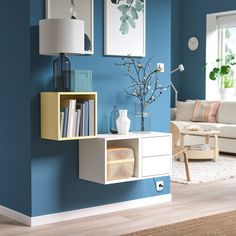 a living room with blue walls and white furniture in the corner, including a book shelf