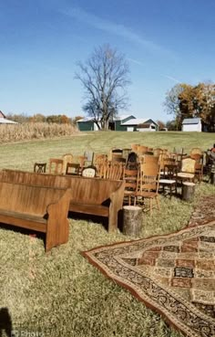 a bunch of chairs and couches sitting in the middle of an open grassy field