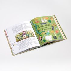 an open children's book with pictures of animals and plants on the page,