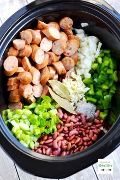 the ingredients in this slow cooker include beans, celery, and sausage