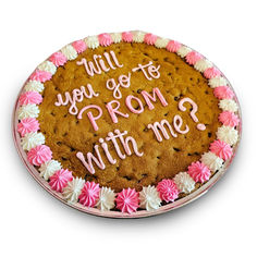 a cookie cake with pink and white frosting on it