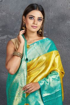 Dazzle at weddings like Bollywood diva Rekha in this royal yellow Kanjivaram saree! The saree is enhanced with blue zari border and zari pallu. It comes with a matching blouse piece. Shop silk sarees in USA from Pure Elegance. Disclaimer: The shown stitched blouse on the model is for display purpose only. The saree comes with a matching blouse piece and finished with fall and piko. Silk Sarees Kanchipuram, Royal Yellow, Tussar Silk Sarees, Kanjivaram Saree, Latest Designer Sarees, Kanjivaram Silk Saree, Green Border, Embroidered Sarees, Border Saree