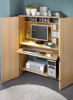 a computer desk with a monitor, keyboard and mouse