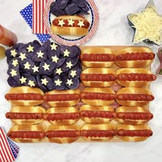 an american flag made out of hotdogs and buns on a marble table