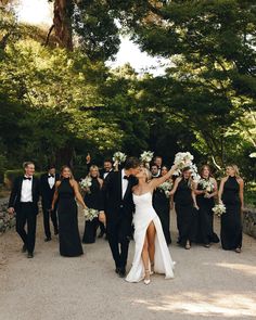 a bride and groom walking with their bridal party