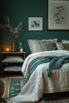 a bedroom with teal walls and pictures on the wall above the bed, along with an area rug