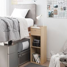 a bedroom with a bed, nightstand and chair