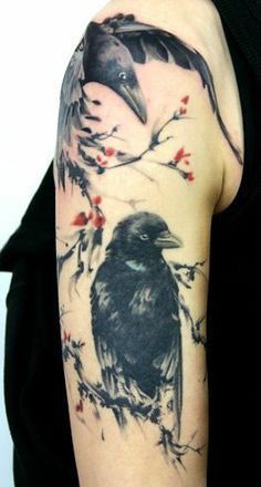 a woman with a tattoo on her arm has a bird and flowers on it's sleeve