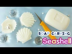 soap carving with seashells and a pair of scissors on the table next to it