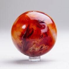 a red glass object sitting on top of a table