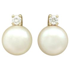 An impressive pair of vintage European cultured pearl and 0.06 carat diamond, 14 karat yellow gold stud earrings; part of our diverse pearl jewelry collections. These fine and impressive vintage pearl stud earrings have been crafted in 14k yellow gold. Each earring is ornamented with a feature 7.95mm cultured pearl. The pearls are each flanked to the upper border with a four claw set modern brilliant round cut diamond. The earrings secure to the reverse with a 14k yellow gold post and butterfly Classic White 14k Stamped Earrings, Vintage White Diamond Earrings For Formal Occasions, Classic Yellow Gold Pearl Earrings With Prong Setting, Classic 14k Gold Pearl Earrings With Prong Setting, Anniversary Brilliant Cut Yellow Gold Pearl Earrings, Formal 14k Gold Pearl Earrings, 14k Gold Round Pearl Earrings For Formal Occasions, Classic Yellow Gold Pearl Earrings With Diamond Accents, Classic Pearl Earrings With Diamond Accents In Yellow Gold