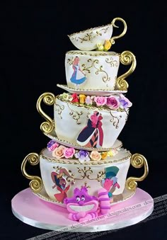 there is a three tiered cake with princesses on it