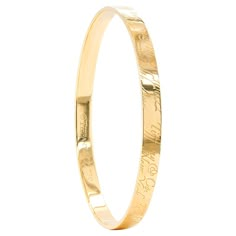 Tiffany & Co solid gold bangle engraved Tiffany & Co 727 Fifth Avenue New York 10022 in script throughout. The bangle weighs a total of 26 grams, measures 5.8mm in width and has an approximate circumference of 7.5 inches. Stamped TIFFANY & CO. 750. Tiffany And Co Jewelry Gold, Simple Bangles Gold, Tiffany And Co Gold, Fifth Avenue New York, Jet Privé, Solid Gold Bangle, Modern Bangle, Western Jewellery, Gold Vans