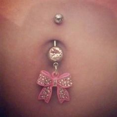 a belly button with a pink bow on it