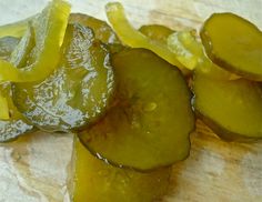 sliced cucumbers sitting on top of a piece of paper next to a knife