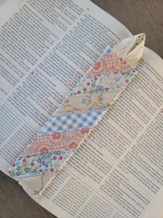 an open book with some fabric on top of it