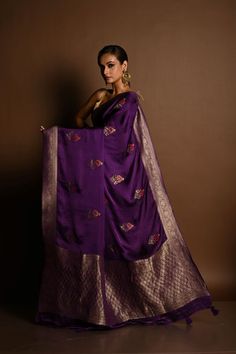 Introducing the Purple Boota Silk Handloom Banarasi Saree—a timeless blend of tradition and luxury. Woven from rich silk, this saree features intricate Boota motifs, a hallmark of Banarasi craftsmanship. The deep purple hue, combined with the handloom's detailed artistry, makes this saree ideal for weddings, festivals, and other special occasions. Its luxurious fabric and classic design ensure that you make an unforgettable statement wherever you go. Pair it with traditional jewelry for a regal and sophisticated look. Elegant Paithani Silk Pre-draped Saree For Designer Wear, Meenakari Raw Silk Pre-draped Saree For Wedding, Ceremonial Tussar Silk Saree With Self Design, Purple Silk Sharara With Pallu, Ceremonial Art Silk Saree With Self Design, Chanderi Saree With Self Design For Ceremonial Occasions, Ceremonial Chanderi Traditional Wear With Self Design, Purple Paithani Silk Pre-draped Saree For Wedding, Ceremonial Pre-draped Saree With Cutdana