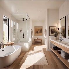 a large white bath tub sitting in a bathroom next to a walk in shower and sink