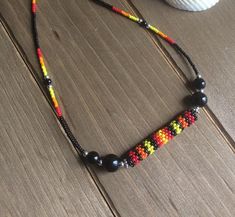 Adjustable Long Necklace With Tiny Beads, Unique Tiny Beads Choker Jewelry, Adjustable Yellow Choker Jewelry, Southwestern Adjustable Jewelry With Colorful Beads, Bohemian Black Jewelry With Spacer Beads, Spiritual Beaded Choker Necklace, Artisan Black Beads Necklace For Festival, Artisan Black Beaded Necklaces For Festivals, Artisan Red Jewelry With Black Beads