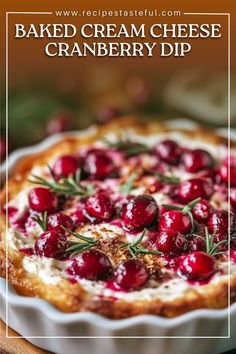 baked cream cheese cranberry dip with rosemary sprigs in a white dish