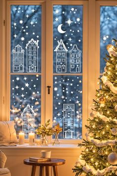 a christmas tree in front of a window with snowflakes on the windowsill