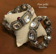 These Glam Victorian Polki Bangles Based in copper with rhodium plating. A perfect accessory for almost anything. This beautifully handcrafted bangle is set in silver and copper alloy and plated with 22k gold. It will go with everything and make your outfit super chic. Perfect to wear to dinner, and perfect gift for family members, friends or bridesmaid. LENGTH Bangle Size - 2.4 Closure - Screw. ...DETAILS -100% top Quality Faux Glass Polki -22K gold and silver Plated silver Silver Bangle With Stone Work For Formal Occasions, Silver Temple Jewelry Bangle For Celebrations, Silver Stone Work Bangle, Silver Bangle With Stone Work For Celebration, Silver Bracelet With Stone Work For Festive Occasions, Silver Temple Jewelry Bangle For Formal Occasions, Silver Bracelets With Stone Work For Festive Occasions, Festive Silver Bracelet With Stone Work, Festive Silver Bracelets With Stone Work