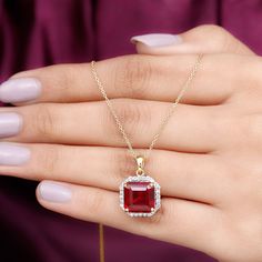 Product Details Elevate every look with the sparkling brilliance of our Classic Halo Pendant, which features a 10 mm asscher-cut created ruby elegantly set in prong setting surrounded by round petite moissanite creating a captivating halo frame, perfect for a striking look. Illuminate your fashion game with the charming allure of this ruby pendant comes with a delicate chain that offers both security and beauty. From casual wear to glamorous evening outfits, upgrade all your fits by wearing this Bridal Halo, Ruby Pendant, Halo Pendant, Ruby Necklace, Asscher Cut, Delicate Chain, Evening Outfits, Prong Setting, Round Shape