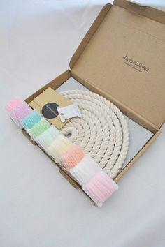 an open box with several different colored ropes in it