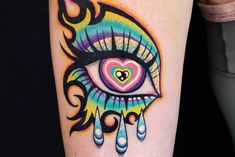 a colorful tattoo with an eye and heart on it