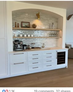 a kitchen with white cabinets and open shelves