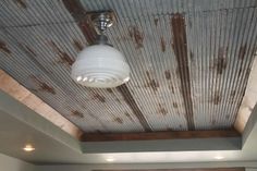 an old tin ceiling with a light fixture