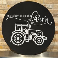 a sign that says life is better on the farm with a tractor in front of it