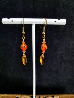 Orange Flames Vintage Double Cathedral Beads Petals Swarovski and Bronze Chain Wire Hook Dangling Earrings for Steampunk Goth Festival Style Orange you glad I made these amazing Summery earrings? Vintage orange double cathedral beads, orange petal beads, and scintillating Swarovski hang from beautiful bronze hooks to make a fantastic set! These measure about 2 1/2 inches long from the top of the hook to the bottom. See something you like, but not in a size, metal, or color you prefer? Please ask! I adore making custom gifts for my clients! Help me make you SPARKLE! We carefully package our jewelry and ship via USPS First Class to ensure your package arrives quickly and safely. Metal Beaded Earrings For Party, Beaded Metal Crystal Earrings, Party Earrings With Czech Glass, Party Czech Glass Crystal Earrings With Ear Wire, Handmade Adjustable Crystal Earrings For Party, Adjustable Faceted Beads Earrings For Festival, Adjustable Crystal Earrings With Faceted Beads For Party, Adjustable Faceted Crystal Earrings For Party, Goth Festival