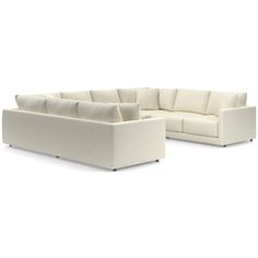 a white sectional couch sitting on top of a white floor