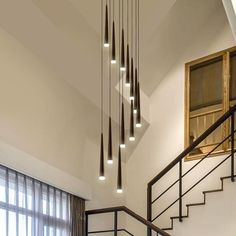 a staircase with lights hanging from the ceiling