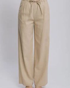 The Drawstring Wide Leg Pants with Pockets are a comfortable and chic addition to any wardrobe. The wide leg design gives these pants a flowy and relaxed fit, perfect for a casual yet stylish look. The drawstring waist allows for adjustable fit and added comfort. With the added functionality of pockets, these pants are both practical and fashionable. Pair them with a tucked-in blouse or a cropped top for a trendy and effortless outfit. Whether for everyday wear or a special occasion, these wide Beige Wide Leg Pants With Elastic Waistband, Relaxed Wide Leg Trousers, Casual Beige Harem Pants For Vacation, Relaxed Harem Pants With Loosely Fitted Hips, Spring Relaxed Wide Leg Harem Pants, Casual Wide Leg Pants With Drawstring, Baggy Wide Leg Pants With Elastic Waistband For Beach, Vacation Baggy Wide Leg Pants, Wide Leg Pants For Vacation