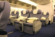 empty seats in an airplane with blue carpet