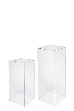 two clear square vases sitting side by side on a white background, one is empty