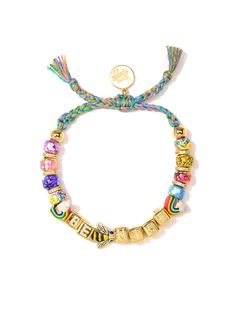 This Be Nice Bracelet is more than just a fashion statement - it's an attitude adjustment! Bright rainbow tie dye threadwork and glass charms shimmer in the light, while pave rhinestone accents and ceramic charms add a bit of extra shine. Make every day a little brighter in style! 6" Adjustable rainbow threadwork Drawstring closure (extendable up to 8") Gold plated brass hardware Glass charms Pave rhinestone charms Ceramic charms Handmade in New York City and Puerto Rico. Due to the handmade nat Adjustable Multicolor Jewelry With Removable Charms, Ceramic Charms, Attitude Adjustment, Rainbow Tie Dye, Bright Rainbow, Daith Piercing, Rainbow Tie, Glass Charms, Arm Party